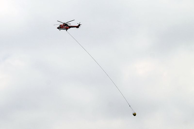 Helikopter Super Puma BNPB melakukan manuver memadamkan sisa api di kawasan Gunung Arjuno, Pasuruan, Jawa Timur, Jumat (8/9/2023). BNPB menambah satu unit helikopter (total dua) tersebut sebagai upaya pemerintah untuk memadamkan sisa api yang membakar seluas 4.796 hektar per Rabu (8/9) hutan dan lahan (karhutla) Gunung Arjuno agar lebih efektif. ANTARA FOTO/Muhammad Mada