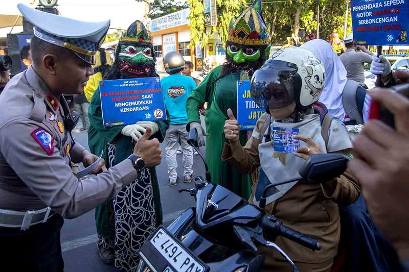 Polisi menegur pengendara motor yang melanggar berlalu lintas saat sosialisasi Operasi Zebra Lodaya di Indramayu, Jawa Barat, Senin (11/9/2023). Polres Indramayu menggandeng sejumlah seniman daerah untuk mensosialisasikan dan mengajak masyarakat menjaga ketertiban dan keselamatan ketika berkendara. ANTARA FOTO/Dedhez Anggara