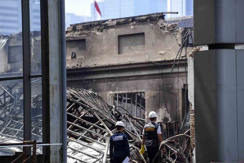 Anggota Laboratorium Forensik Polda Metro Jaya berjalan di area pasca kebakaran Museum Nasional di Jakarta, Minggu (17/9/2023). Menurut data dari Suku Dinas Penanggulangan Kebakaran dan Penyelamatan Jakarta Pusat, pasca kebakaran Museum Nasional yang diduga akibat korsleting arus listrik yang terjadi di bedeng proyek renovasi museum tersebut berakibat empat ruangan terbakar yakni dua ruangan di sayap sebelah kanan dan dua ruangan di bagian tengah. ANTARA FOTO/M Risyal Hidayat